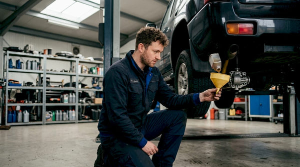 Technician pouring Haldex oil into AWD coupling