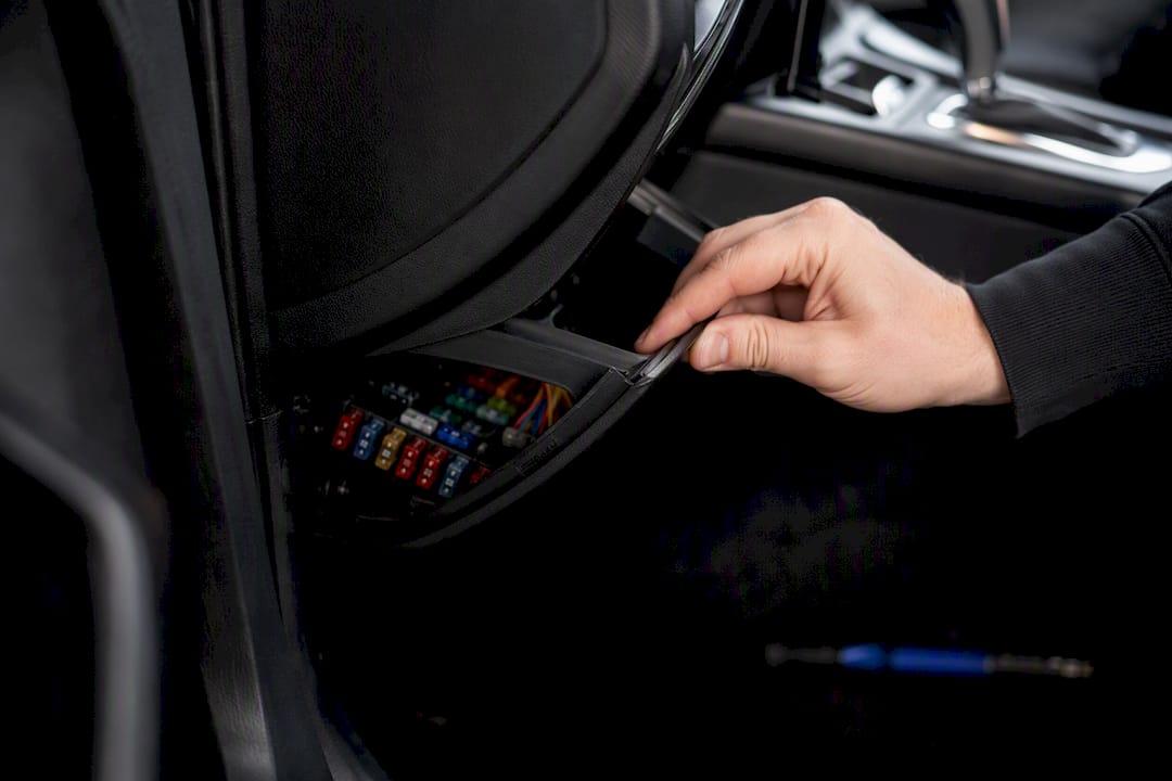 Hand lifting car fusebox cover interior