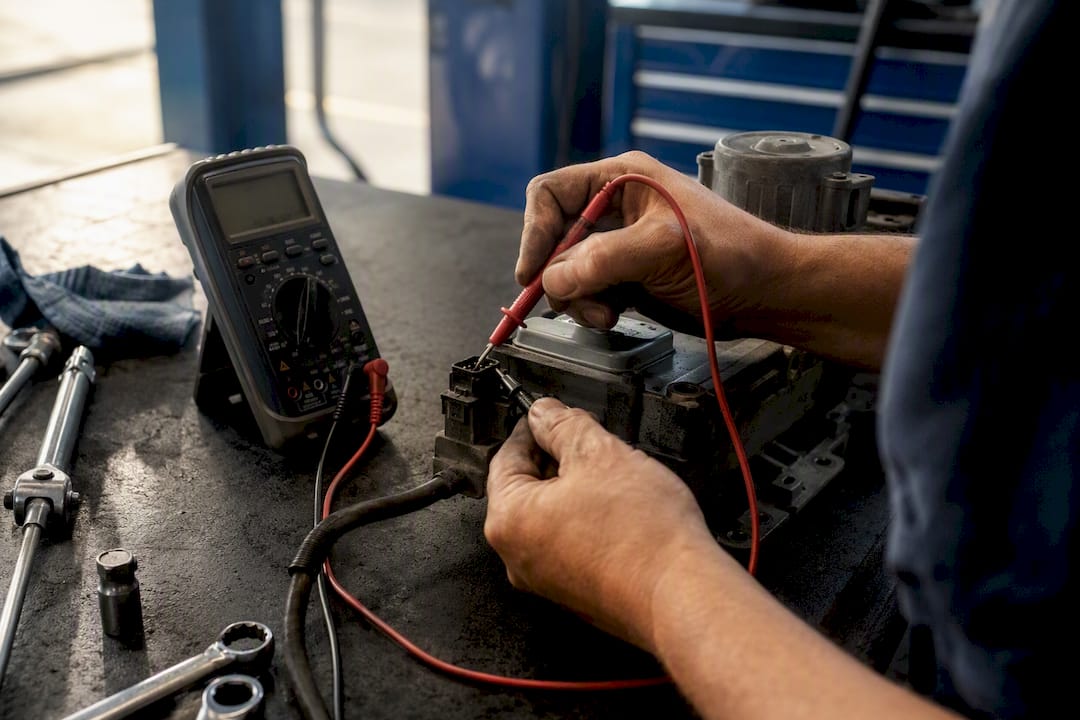 Technician testing Haldex pump connector with multimeter