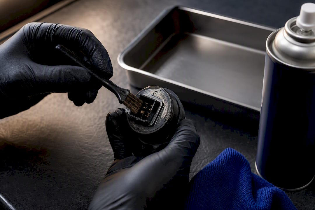 Mechanic cleaning AWD solenoid contacts